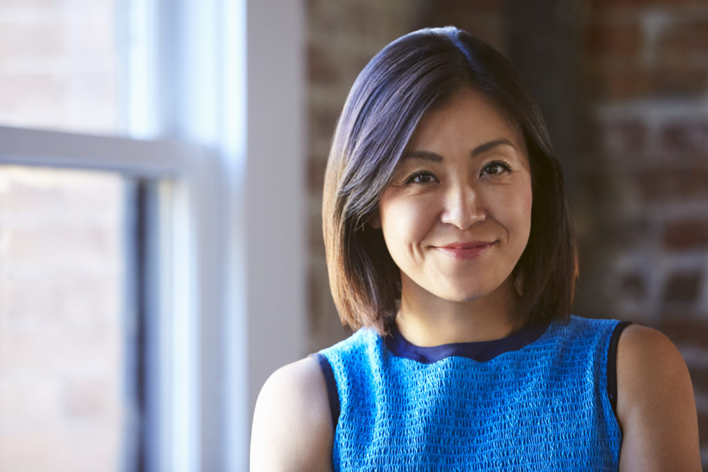 Portrait Of Businesswoman In Office Standing By Window